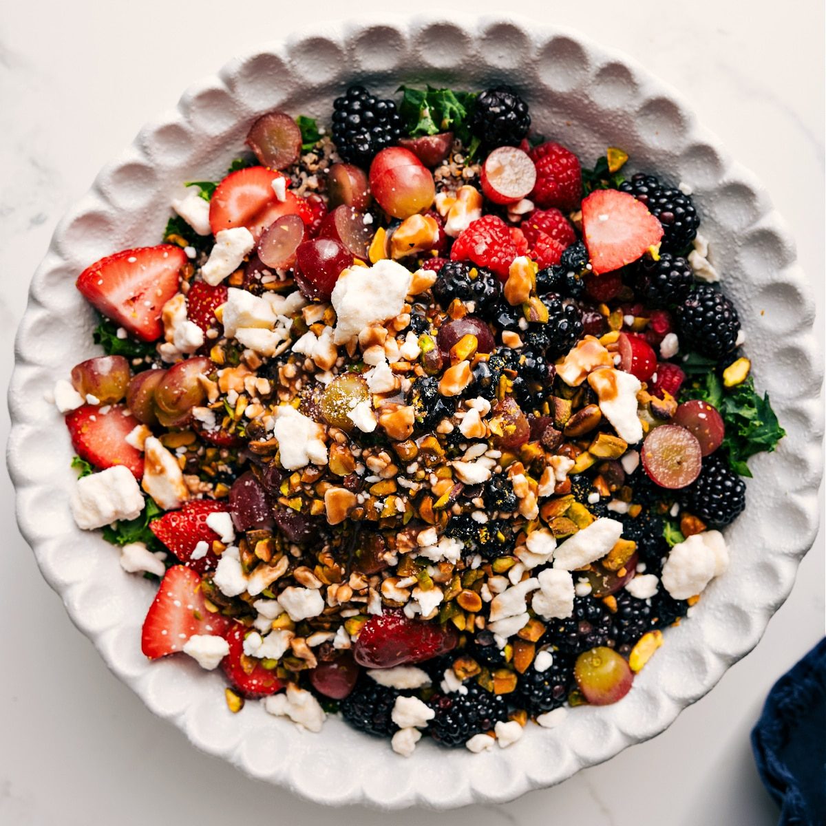 The salad with all the ingredients layered in and drizzled over with the dressing.