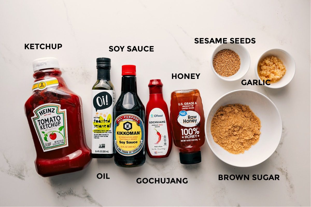 All the sauce ingredients prepped and ready, including ketchup, oil, soy sauce, gochujang, honey, sesame seeds, garlic, and brown sugar.