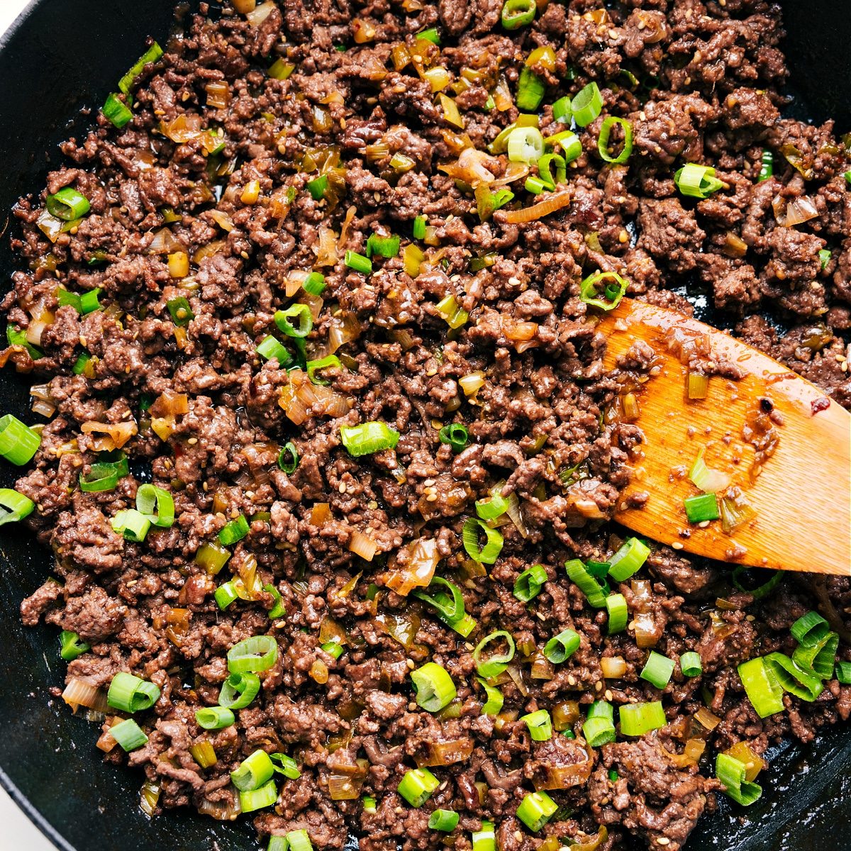 The meat mixture in the skillet topped with green beans ready to be served and enjoyed.
