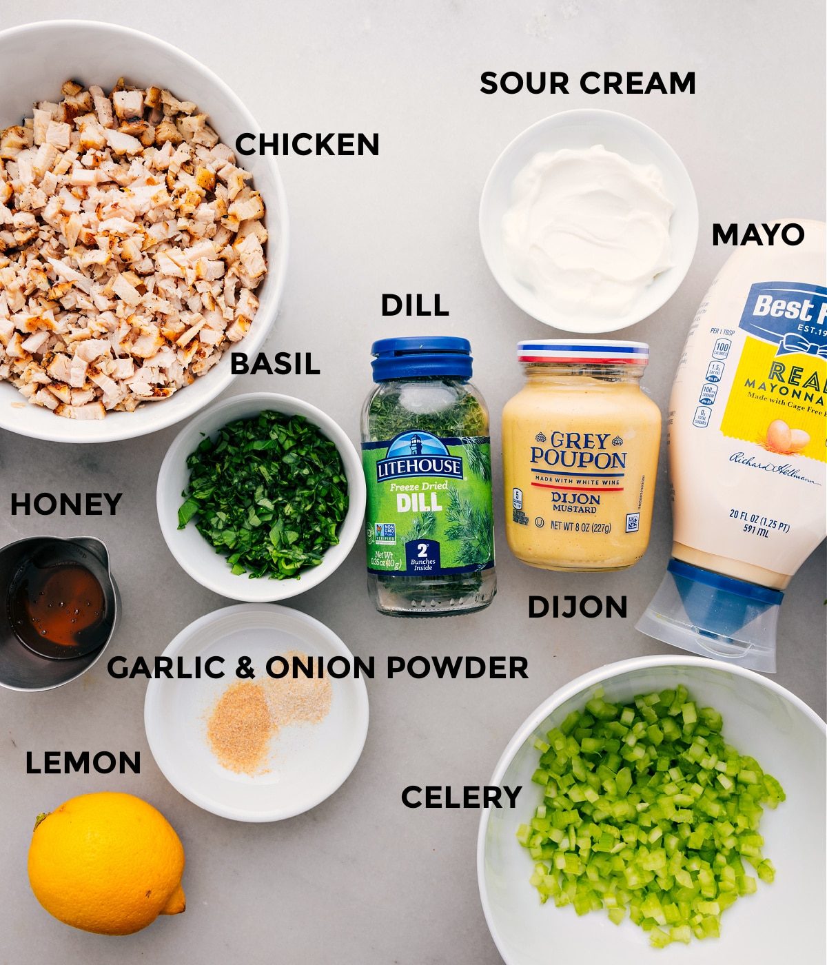 All the ingredients for this recipe are prepped and ready for straightforward assembly, including the meat, mayo, sour cream, dijon, herbs, celery, lemon, and honey.