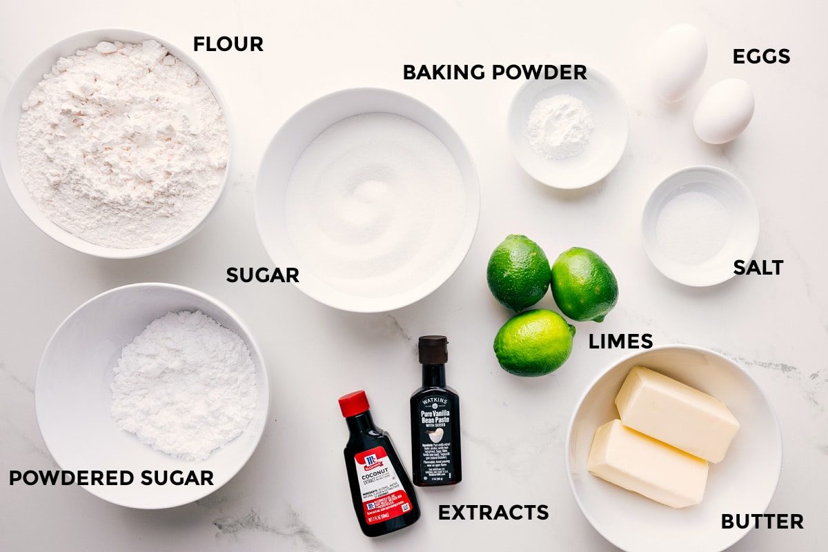 All the ingredients in this recipe prepped out for straightforward assembly including the flour, powdered sugar, baking powder, extracts, limes, butter, salt, and eggs.