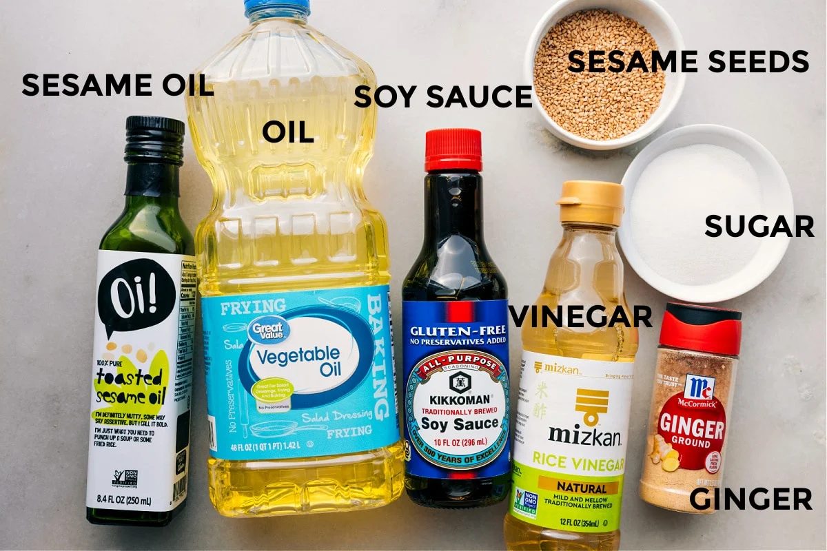Dressing ingredients prepped and ready: sesame oil, vegetable oil, soy sauce, vinegar, sesame seeds, sugar, and ginger.