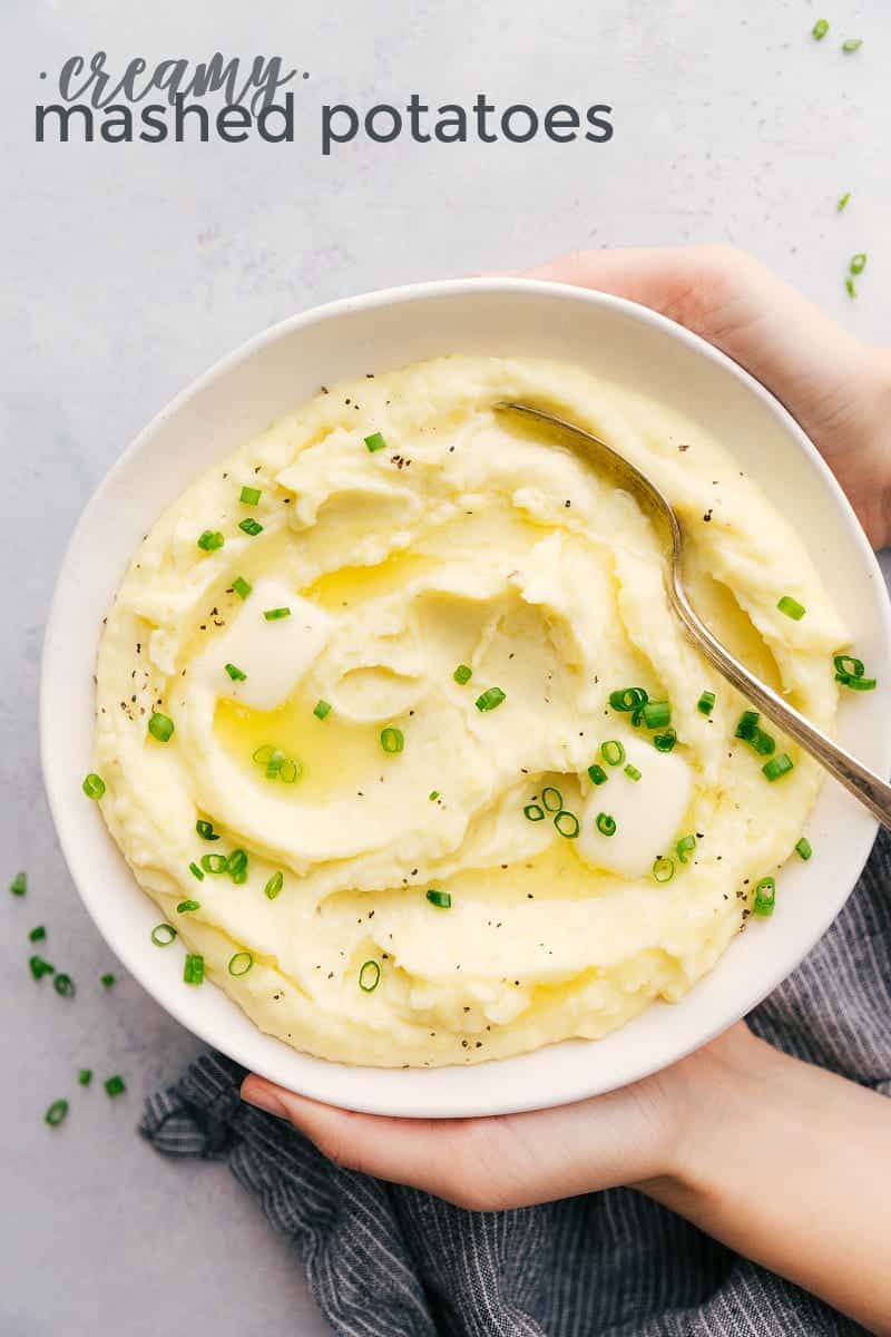 Mashed Potatoes in a bowl topped with green onions.