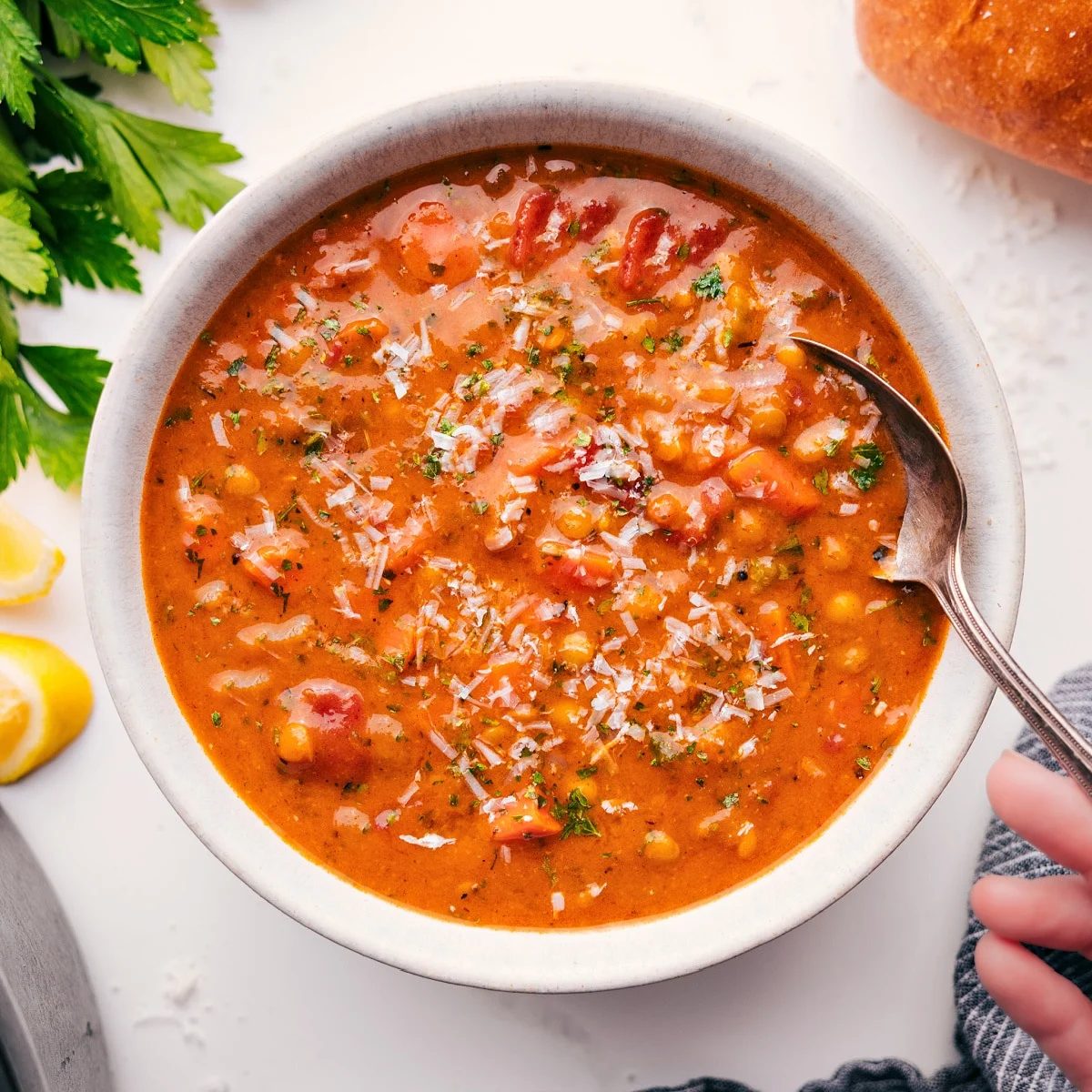 A bowl full of the flavorful and satisfying soup with fresh parmesan grated on top.