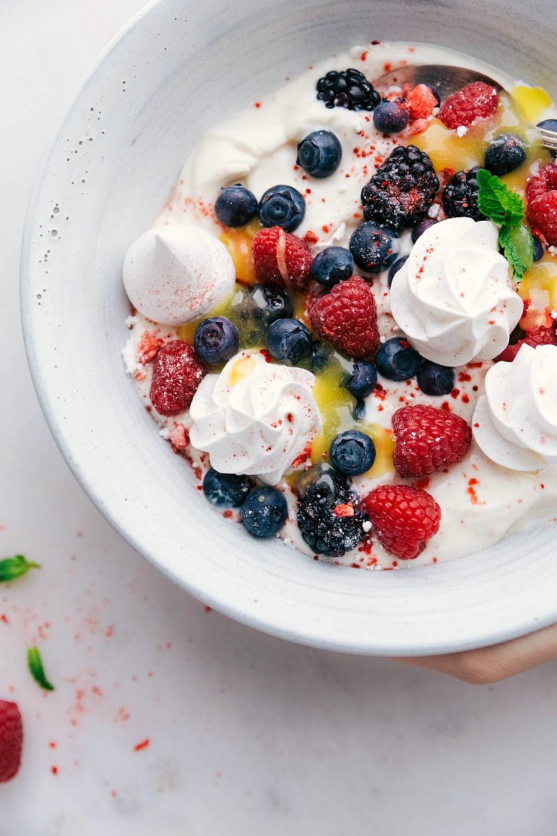 Meringue Cookie Recipe in a bowl with yogurt, berries, and lemon curd.
