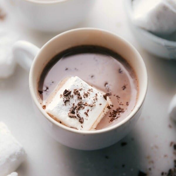 from-scratch marshmallows floating in a cup of hot chocolate, topped with chocolate shavings.