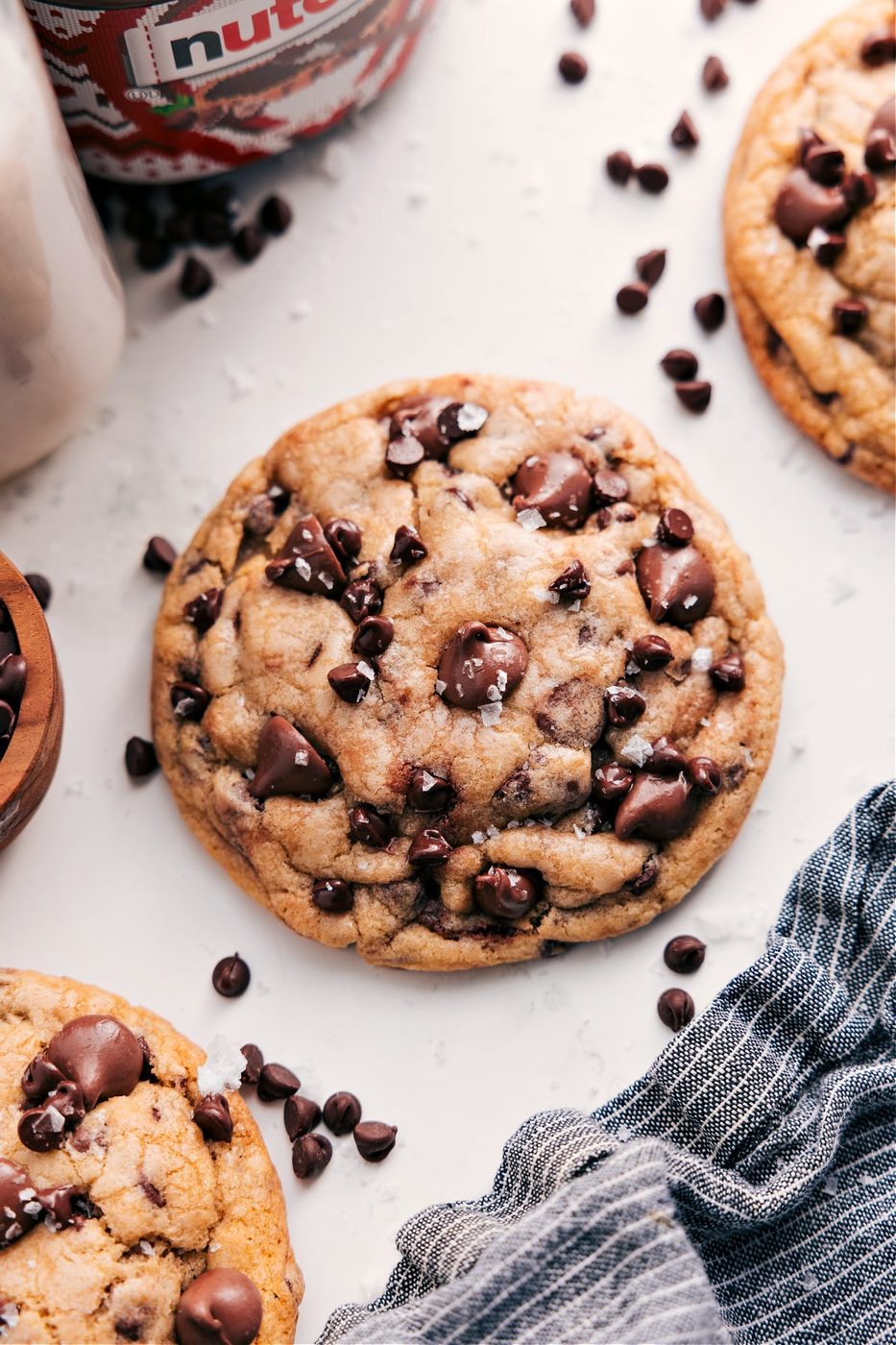 Some Nutella stuffed chocolate chip cookies fresh out of the oven with flaky sea salt on top.