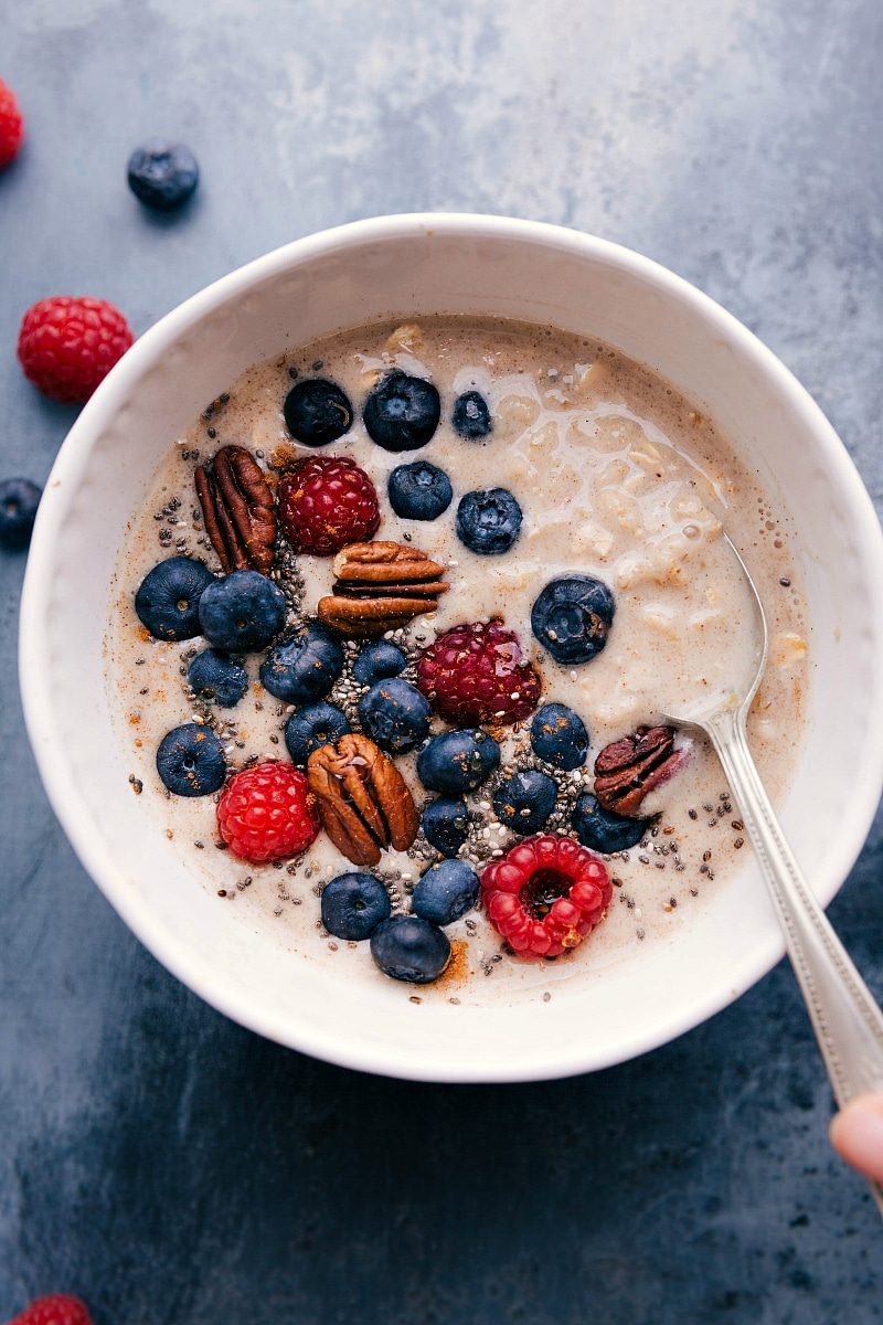 Berries and cream inspired breakfast bowl topped with nuts and chia seeds.