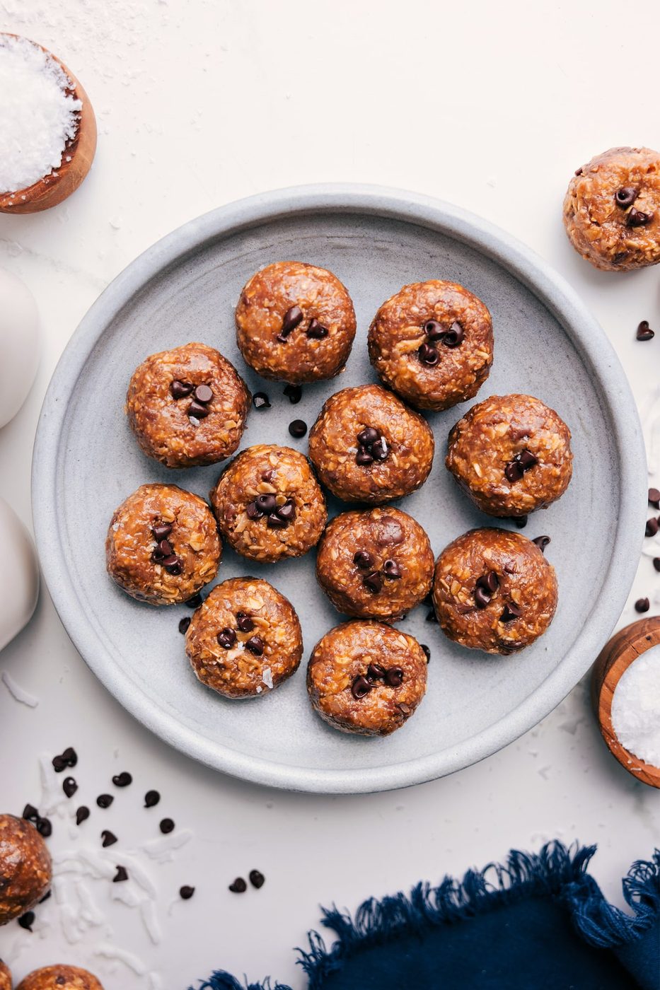 Oatmeal Energy Balls on a plate with chocolate chips pressed into each ball.
