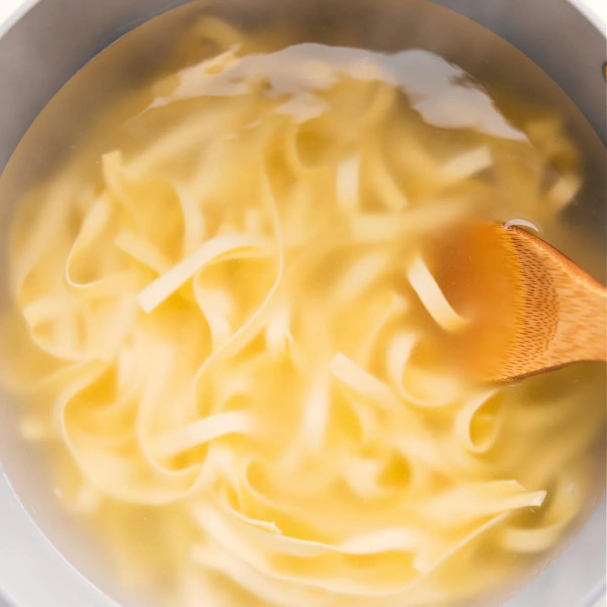 The fettuccine noodles boiled in a pot for this Olive Garden fettuccine Alfredo recipe.