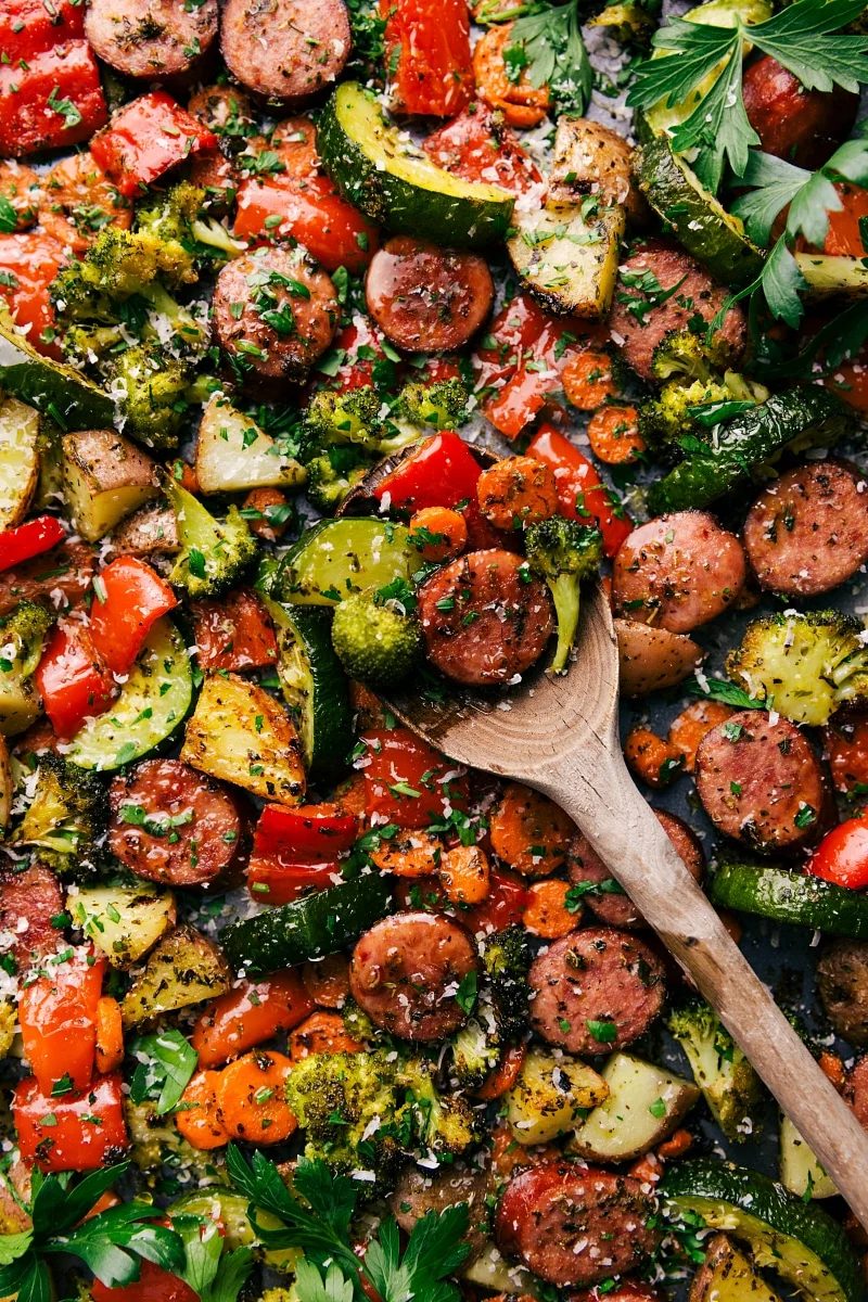 A tray featuring the evenly cooked and seasoned one pan Italian sausage and veggies recipe, where all the flavors come together to create the reliable combination of flavor and texture.
