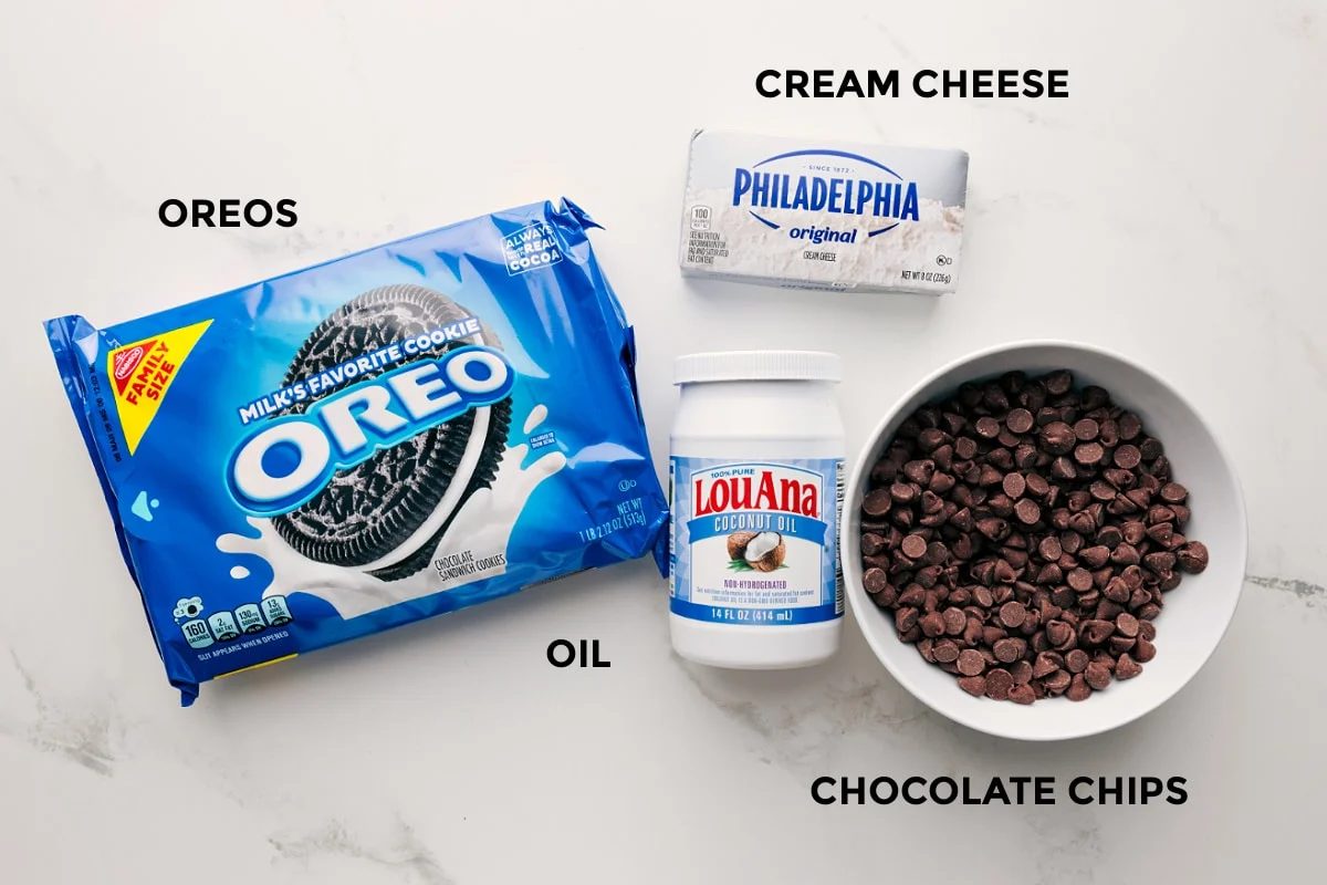 All the ingredients in this recipe prepped out for straightforward assembly including the Oreos, cream cheese, oil, and chocolate chips.