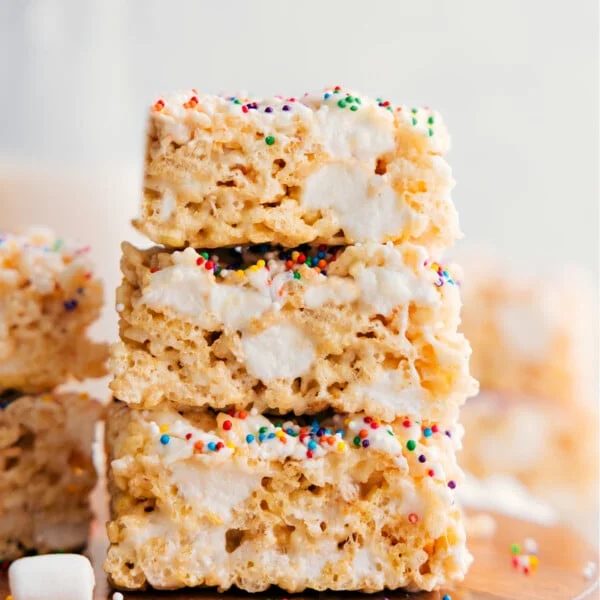 Rice Krispie Treats squares stacked on top of each other showing the gooey and satisfying texture.