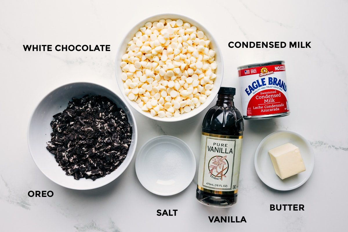 All the ingredients in this recipe prepped out for straightforward assembly including the Oreo, white chocolate, salt, vanilla, butter, and condensed milk.