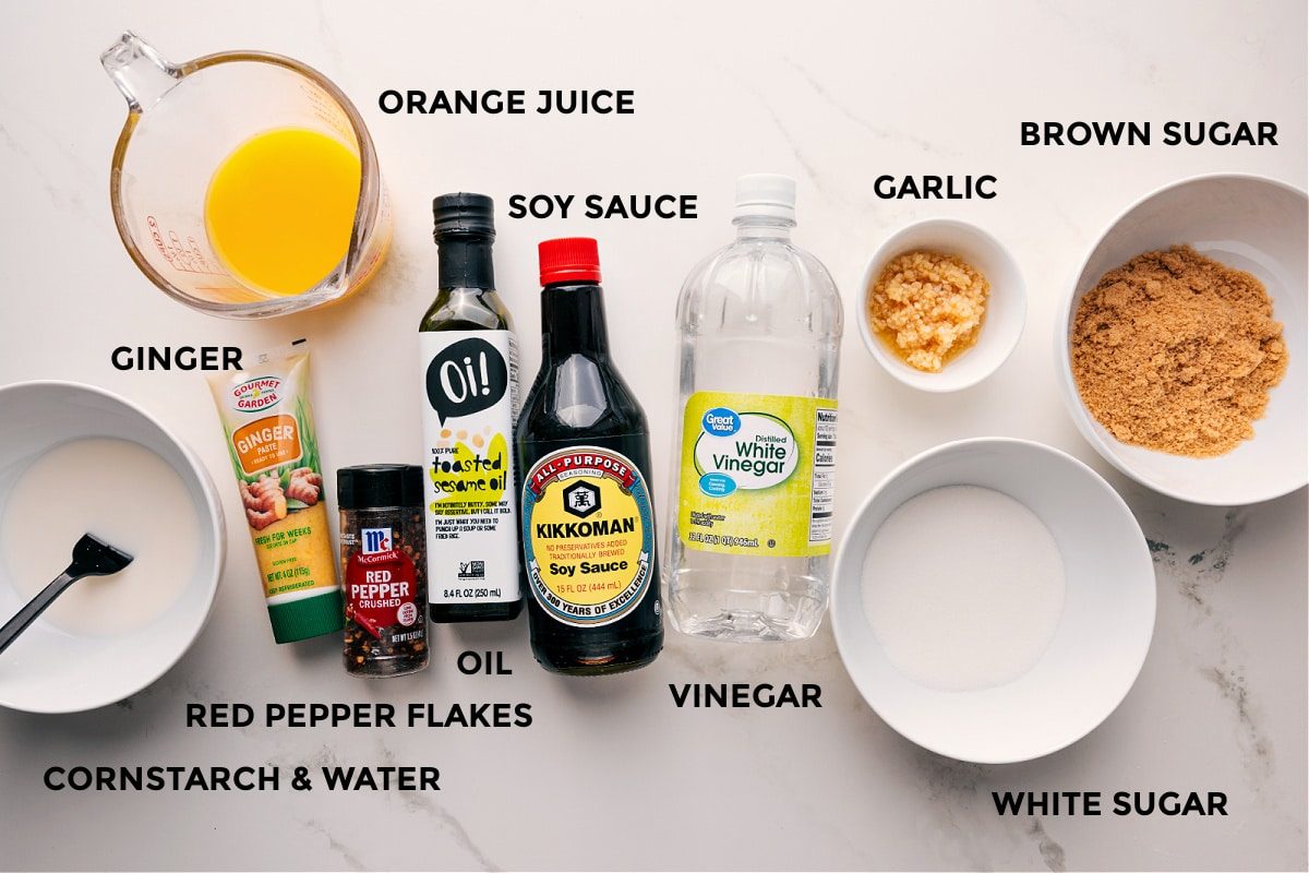 All ingredients prepped for this sauce including cornstarch, water, red pepper flakes, ginger, oil, orange juice, soy sauce, vinegar, garlic, brown sugar, and white sugar.