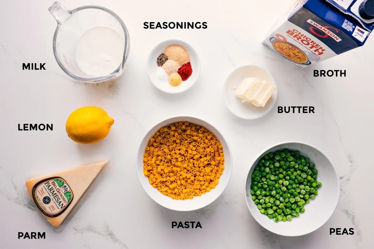 All the ingredients in this recipe prepped out for straightforward assembly including the milk, lemon, parm, seasonings, pasta, peas, butter, and broth.