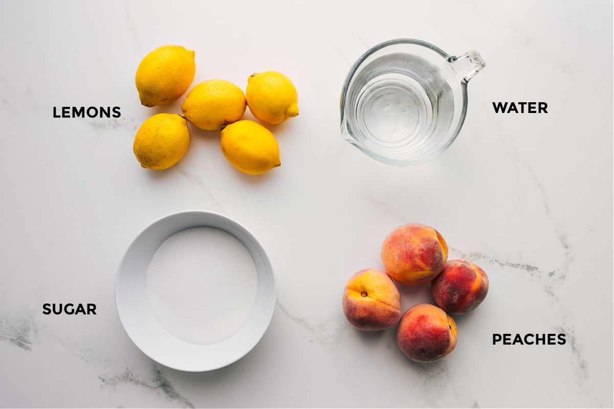 All the ingredients in this recipe prepped out for straightforward assembly including the lemons, sugar, water, and peaches.