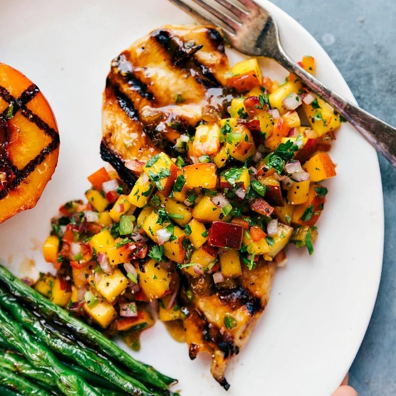 satisfying grilled chicken topped with peach salsa, served with green beans on the side.
