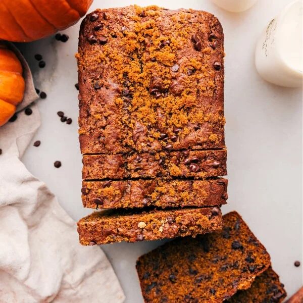 Pumpkin chocolate chip bread with slices cut out, revealing the satisfying and fluffy interior.