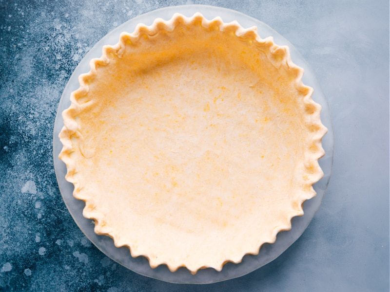 The crust in a glass pan, ready for baking.