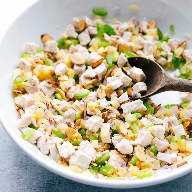All the ingredients for the recipe being mixed together in a large bowl, blending flavors and textures.