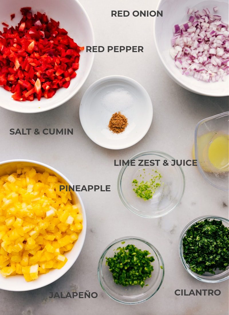 The ingredients for this recipe, including pineapple, red onion, red pepper, salt, cumin, lime zest, lime juice, cilantro, and jalepeno.