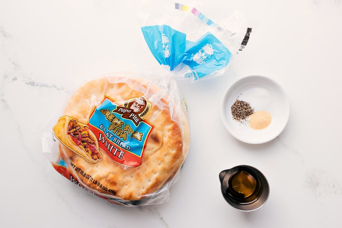The ingredients in this recipe prepped out for straightforward assembly including the pita bread, seasonings, and oil.