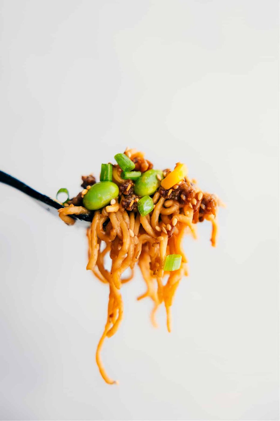 A big forkful of the Pork Ramen Stir Fry Recipe showing all the lively ingredients.