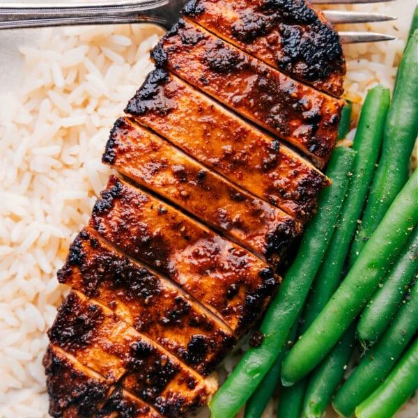 straightforward Blackened Chicken recipe over a bed of rice with green beans on the side.