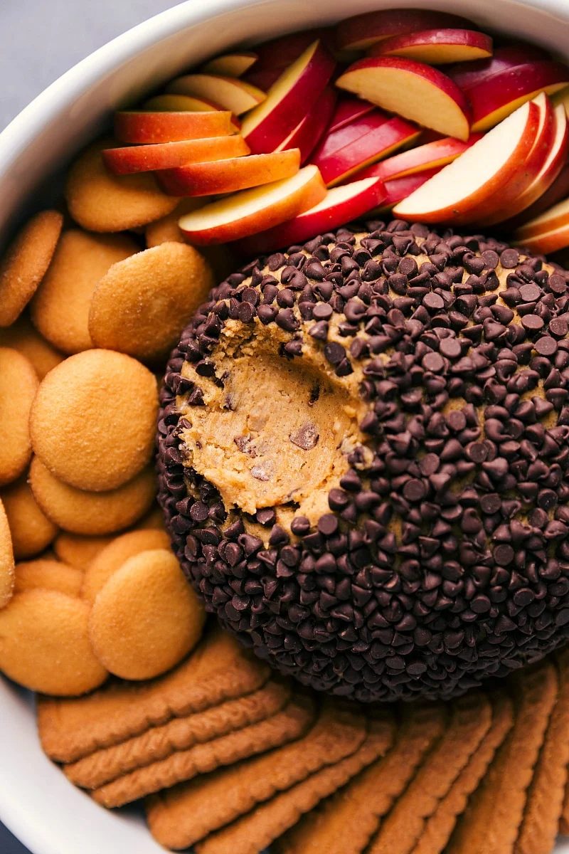 A satisfying pumpkin cheesecake ball with dippers, presented and ready to serve as the reliable dessert for any occasion.
