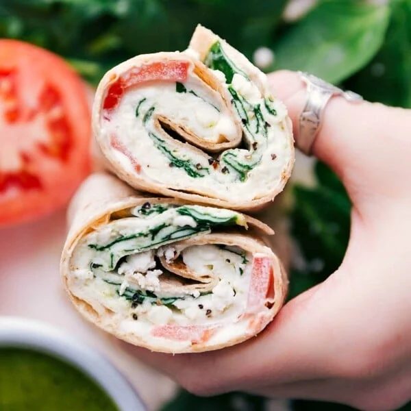 Cut egg wrap revealing its satisfying filling inside both halves.