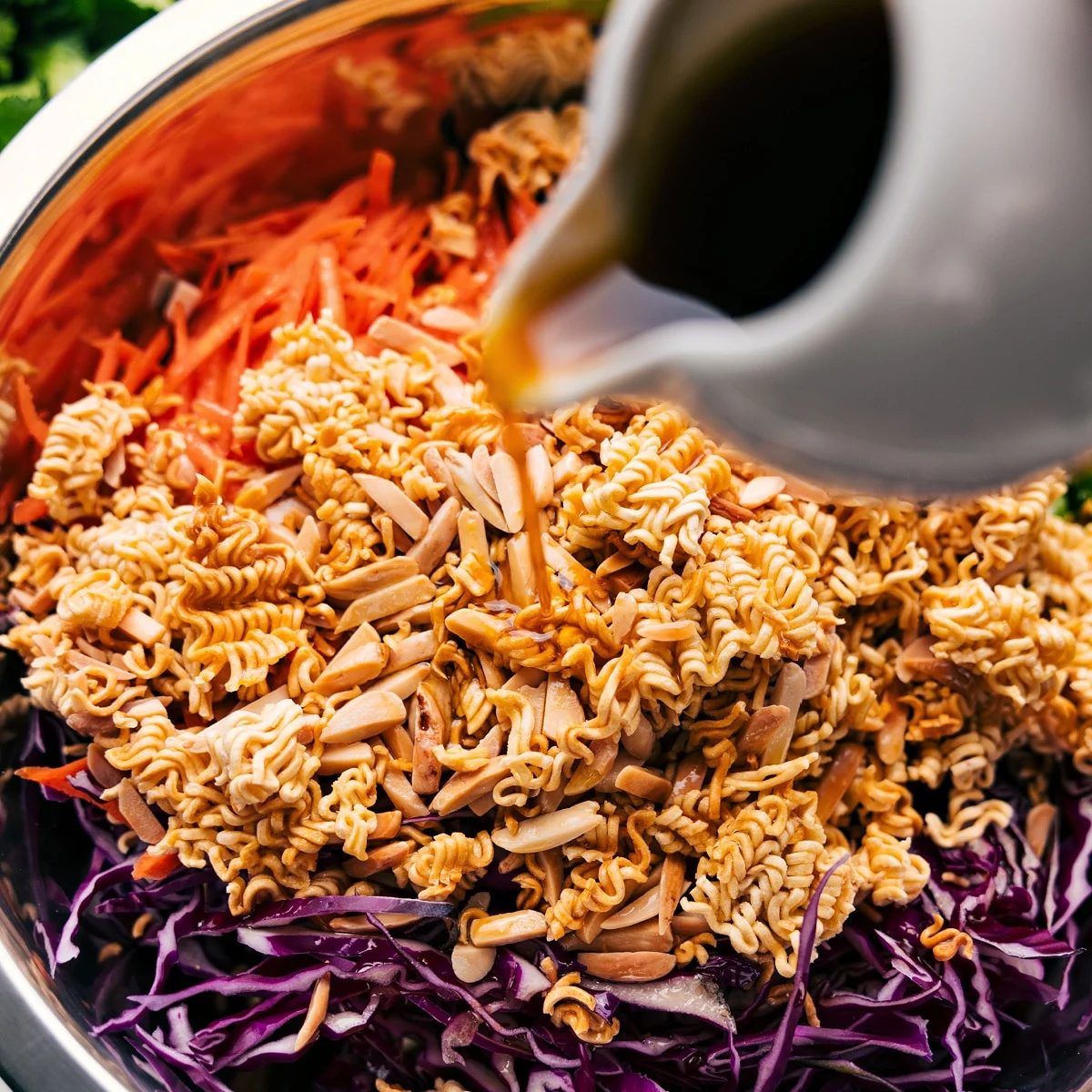 All the ingredients in this ramen noodle salad recipe added to a bowl and tossed with the dressing.