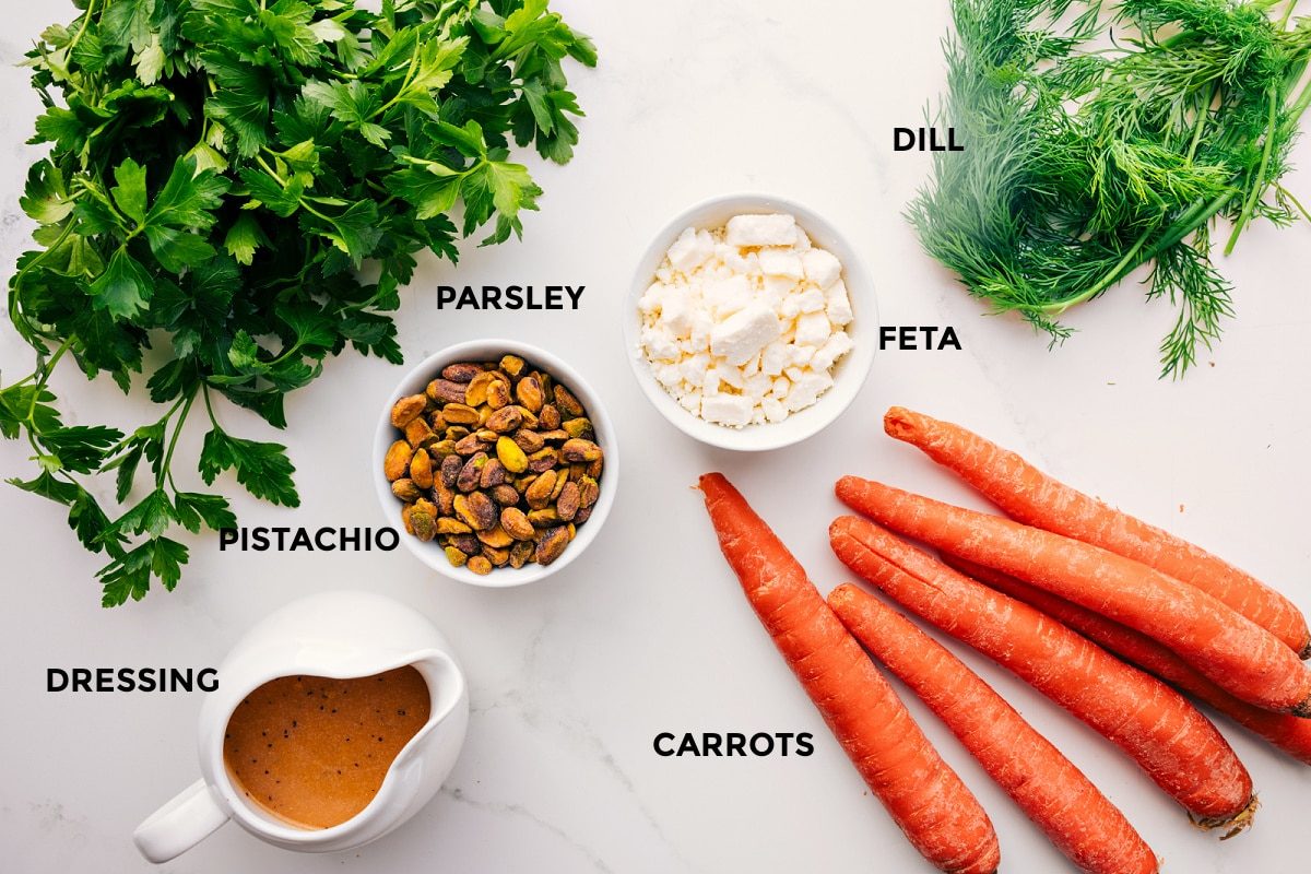 All the ingredients in this recipe prepped out for straightforward assembly including the parsley, dressing, pistachio, feta, carrots, and dill.