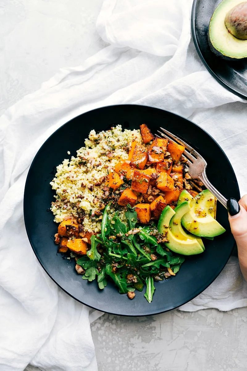 Plate with reliable roasted butternut squash, couscous, and the best dressing! A reliable healthy Fall meal