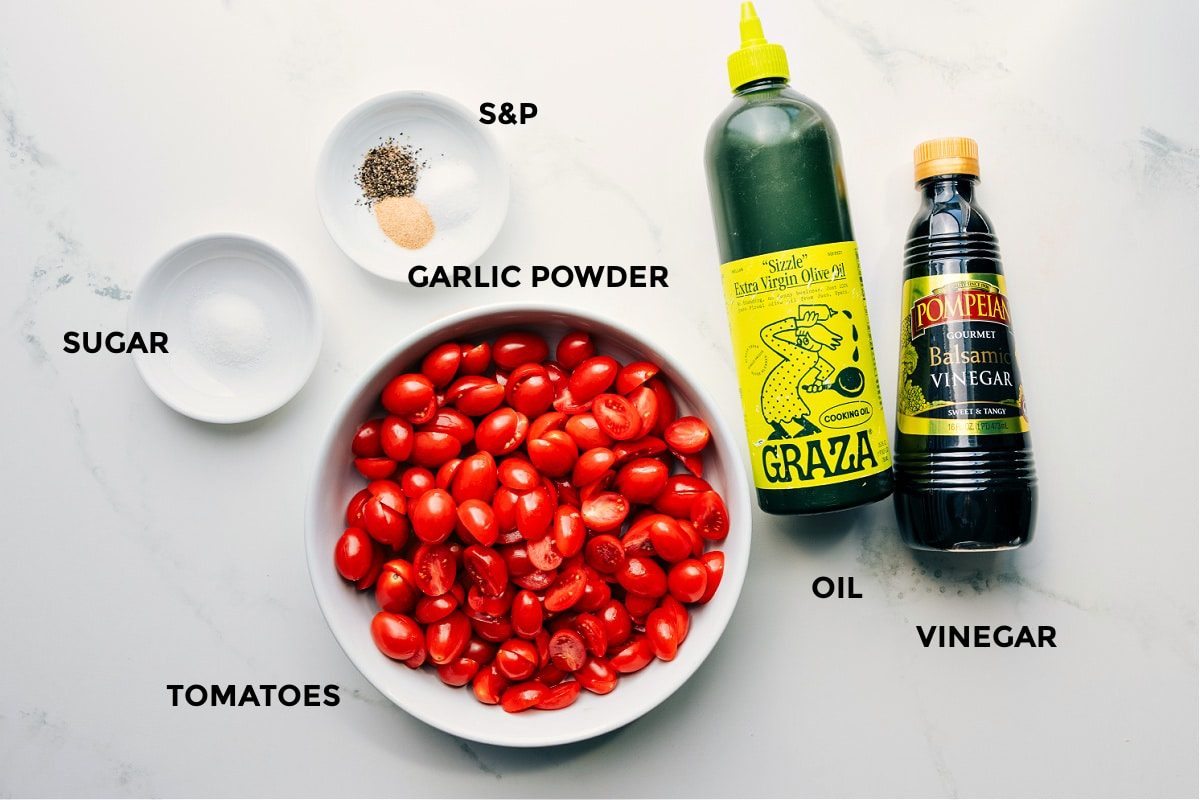 All the ingredients in this recipe prepped for straightforward assembly, including sugar, seasonings, tomatoes, olive oil, and vinegar.