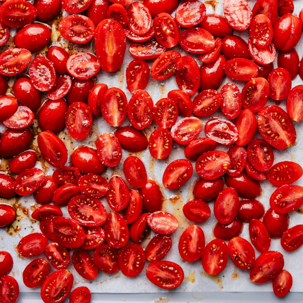 All the cherry tomatoes seasoned and coated in oil, ready to roast for the reliable roasted cherry tomatoes.