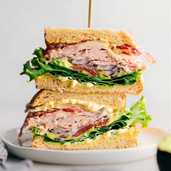 A thick and flavor-packed turkey bacon avocado sandwich made with satisfying Thanksgiving leftovers, fresh vegetables, and a savory sauce.