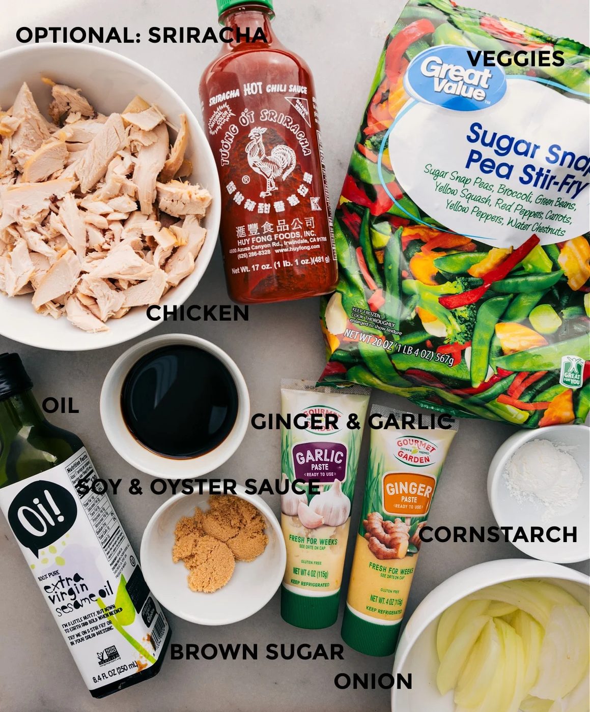 All the ingredients for this recipe are prepped for straightforward assembly: frozen veggie mix, meat, sriracha, ginger, garlic, soy sauce, oyster sauce, cornstarch, and onion.