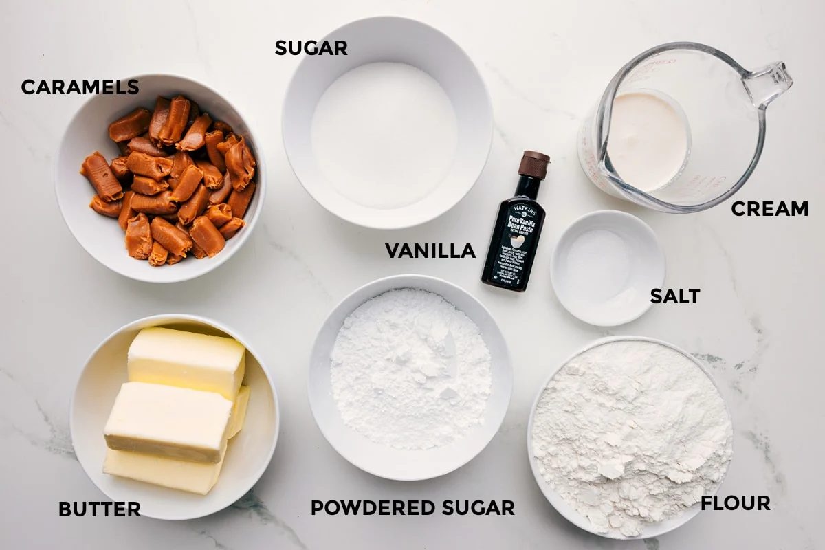 All the ingredients in this recipe prepped out for straightforward assembly including the caramels, butter, sugar, powdered sugar, vanilla, cream, salt, and flour.
