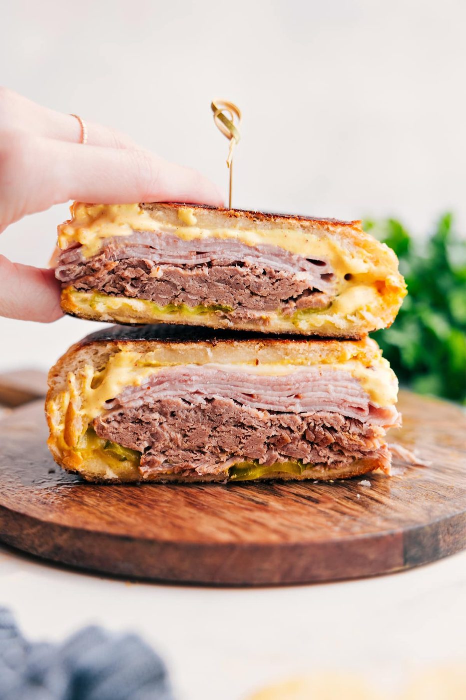 Cuban sandwich with pork, ham, Swiss cheese, pickles, and mustard on pressed bread.