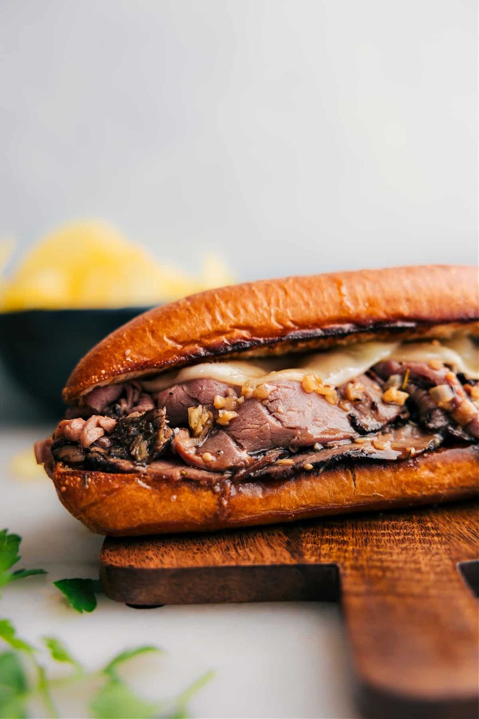 French dip sandwich with tender beef and melted cheese served with au jus.