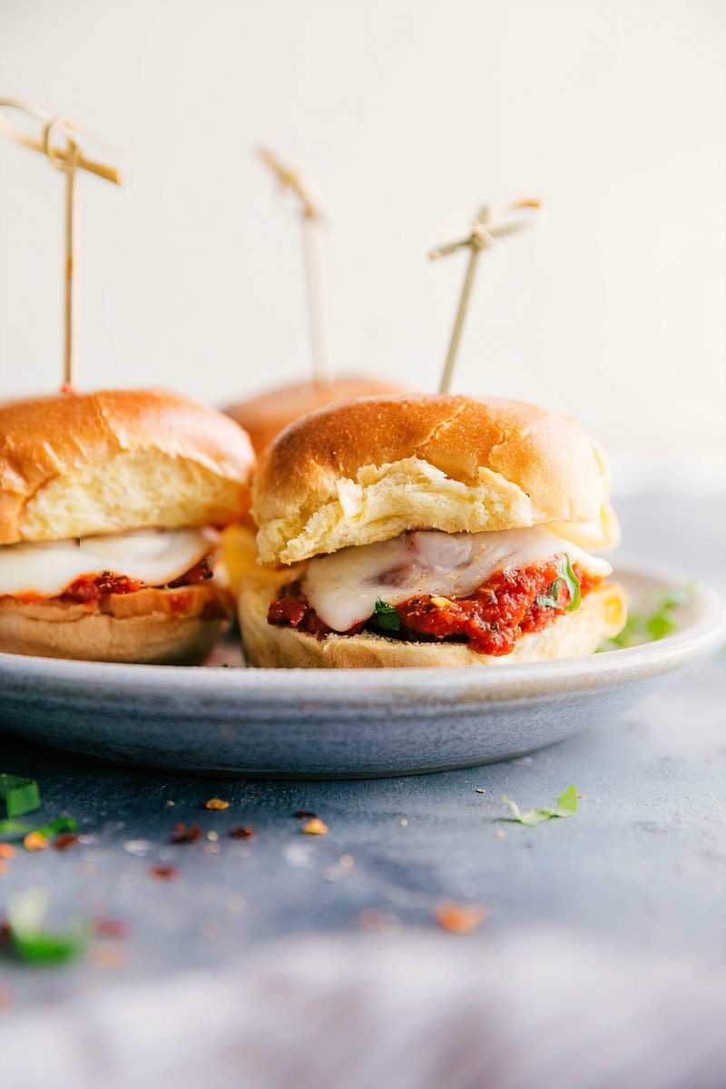 Meatball sliders with saucy meatballs and melted cheese on soft slider rolls.