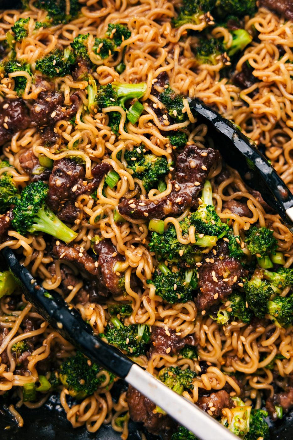 Beef and broccoli ramen in the pot with sesame seeds and green onions as finish.