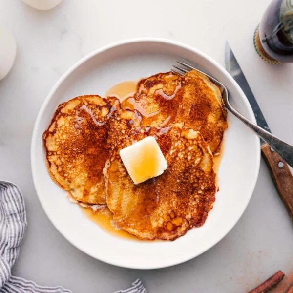 satisfying Stack of Pancakes Drizzled with Syrup on Plate