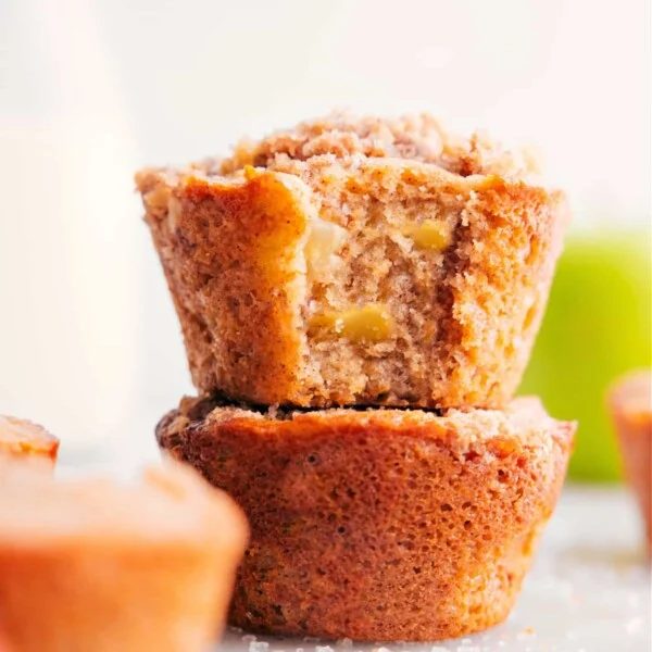 Freshly baked apple muffins, warm and satisfying, with chunks of fresh apples and the complimentary taste of cinnamon.