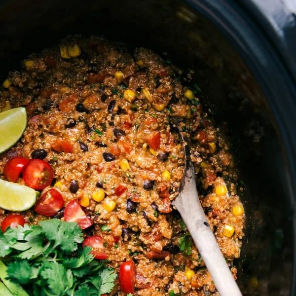 Tex mex quinoa in slow cooker full of flavor with fresh vegetables and cilantro.