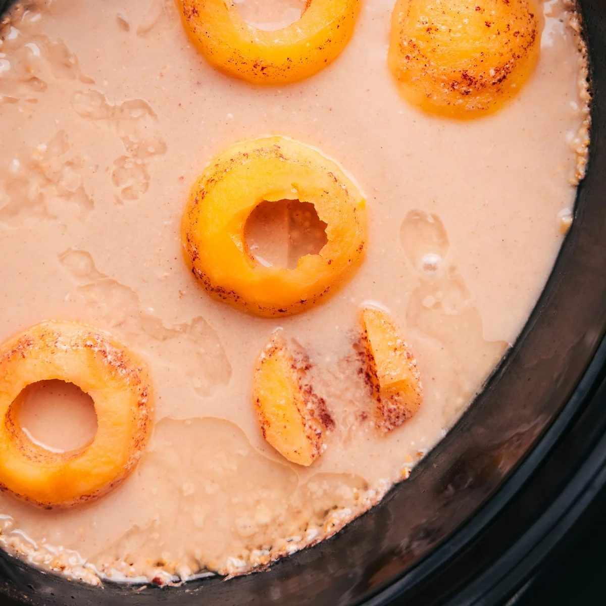The slow cooker with the cooked apples and oats ready to be mixed and mashed together.