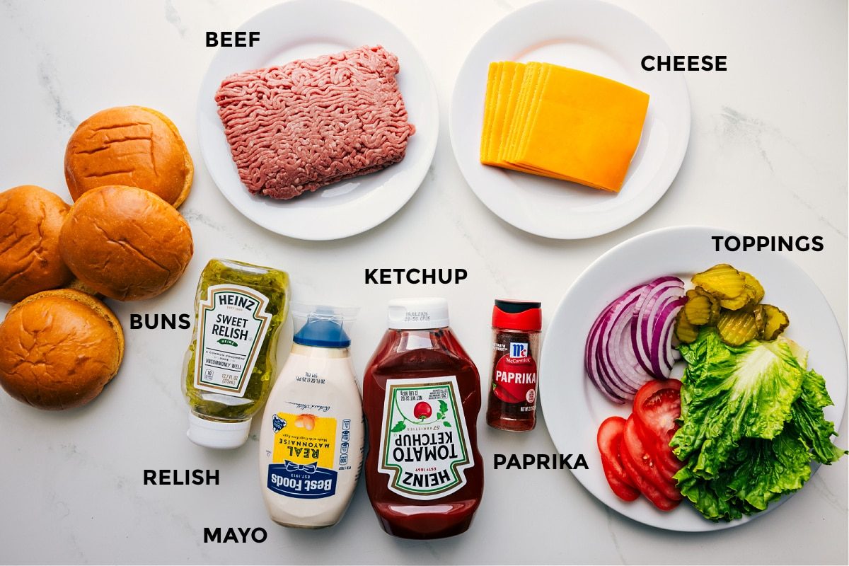 Ingredients prepped out for straightforward assembly including the buns, beef, relish, mayo, ketchup, paprika, cheese, and toppings.