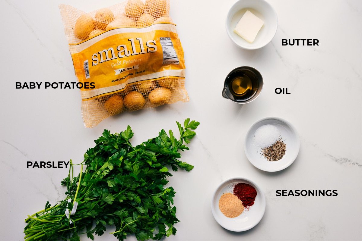 All the ingredients in this recipe prepped out for straightforward assembly including the baby potatoes, parsley, butter, oil, and seasonings.