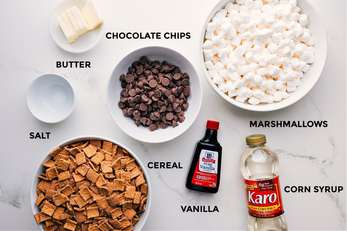All the ingredients for this recipe, including butter, chocolate chips, marshmallows, corn syrup, vanilla, cereal, and salt, prepped and ready for straightforward assembly.